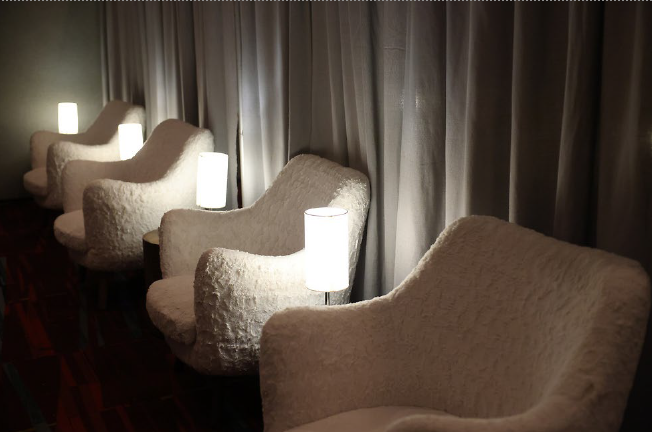 White chairs in low lit room