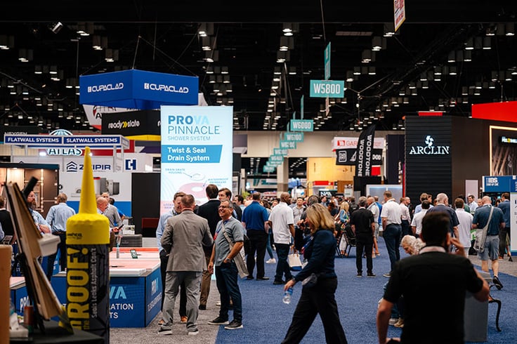 Crowd of people walking around exhibit floor