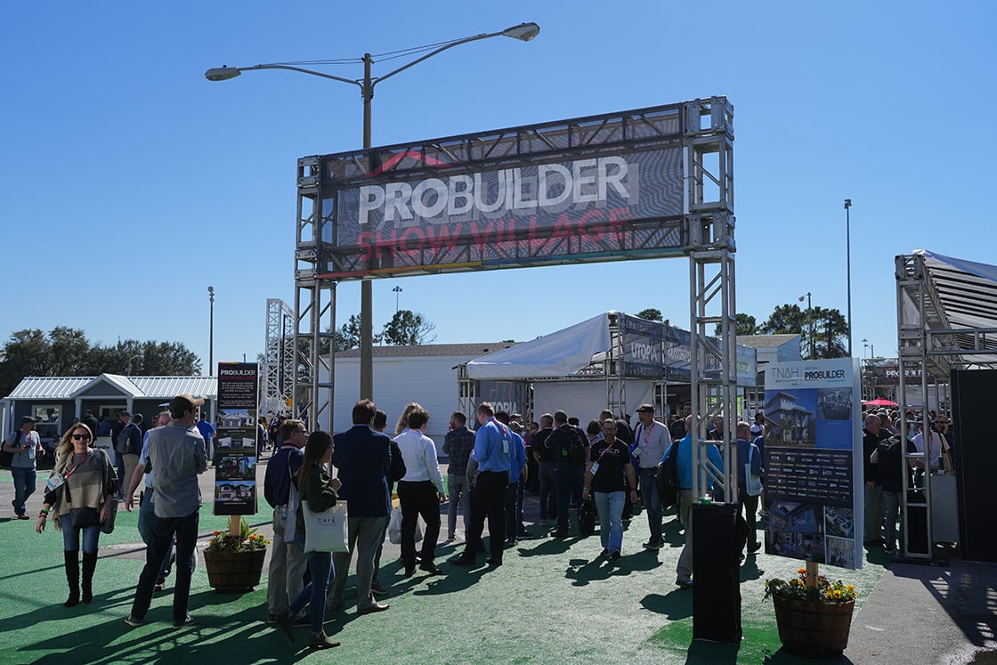 People walking outside to outdoor exhibits