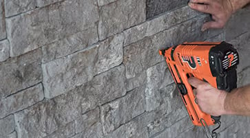 Gray stone wall and power drill