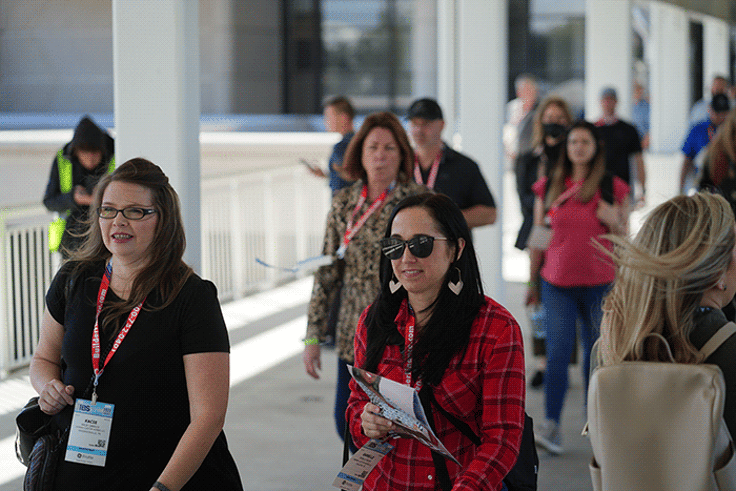 Two ladies walking through hall