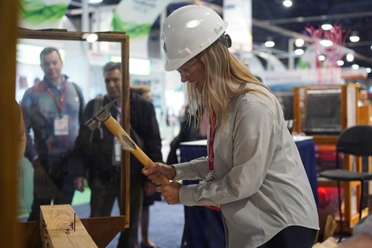 Woman in hardhat holding hammer