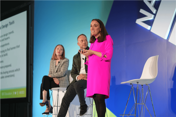 Four women sitting on stage talking