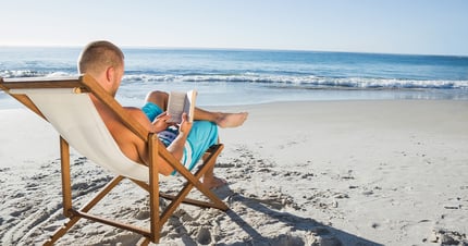 Man reading on the beach