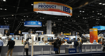 New Product Zone sign hangs above expo show floor