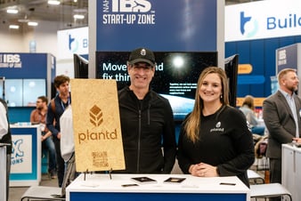A picture of a man and a woman from Plantd in their booth in the IBS Start up Zone.